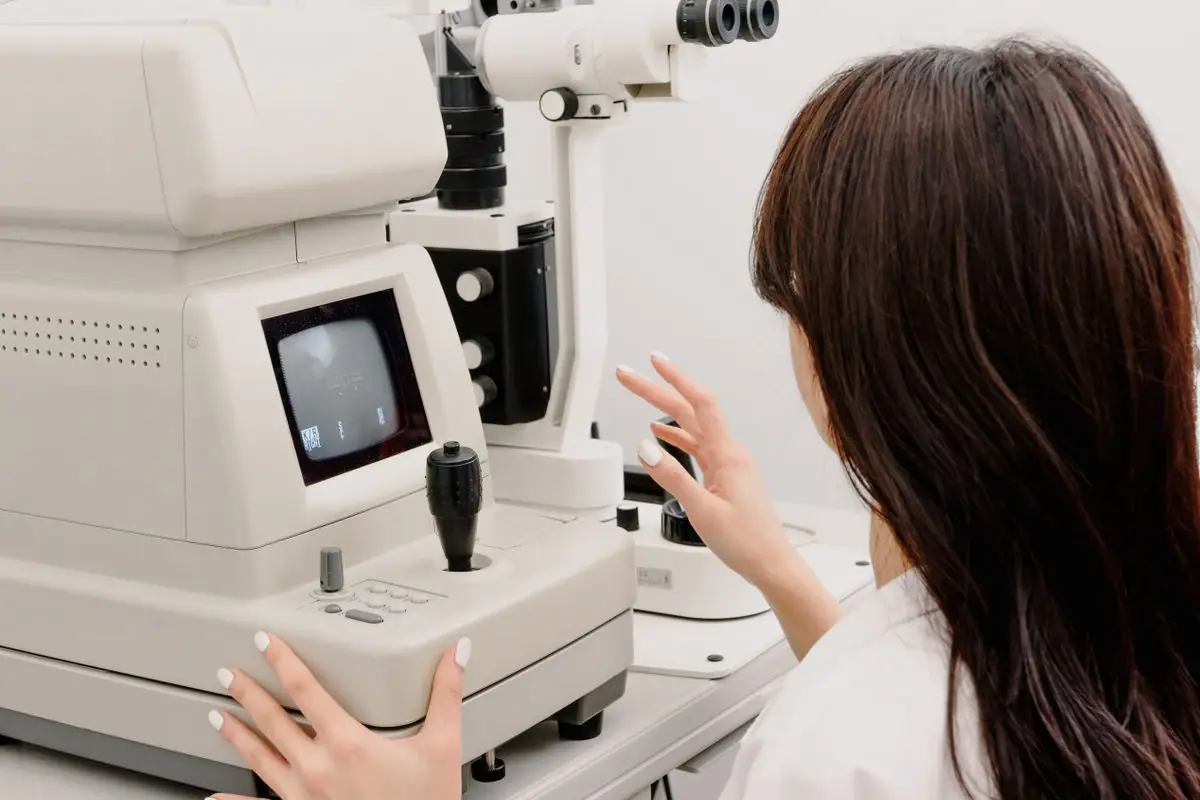 A clinician operating an eye-imaging machine